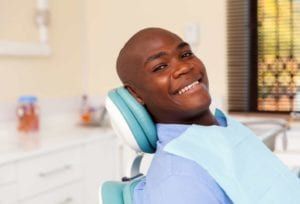 smiling patient undergoes dental checkup