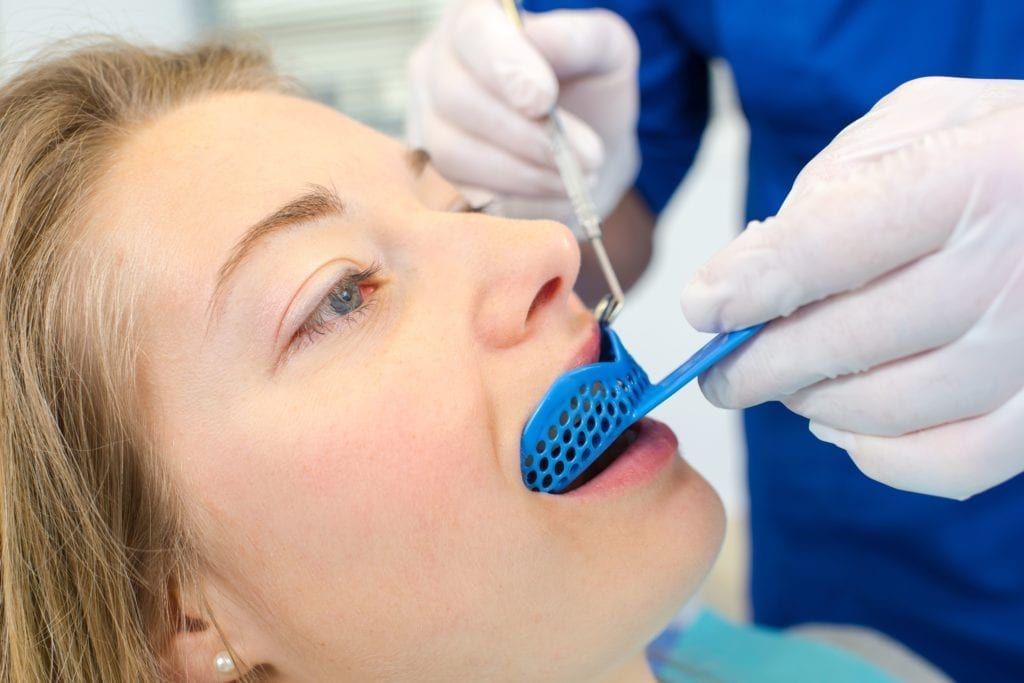 woman having a dental impression taken