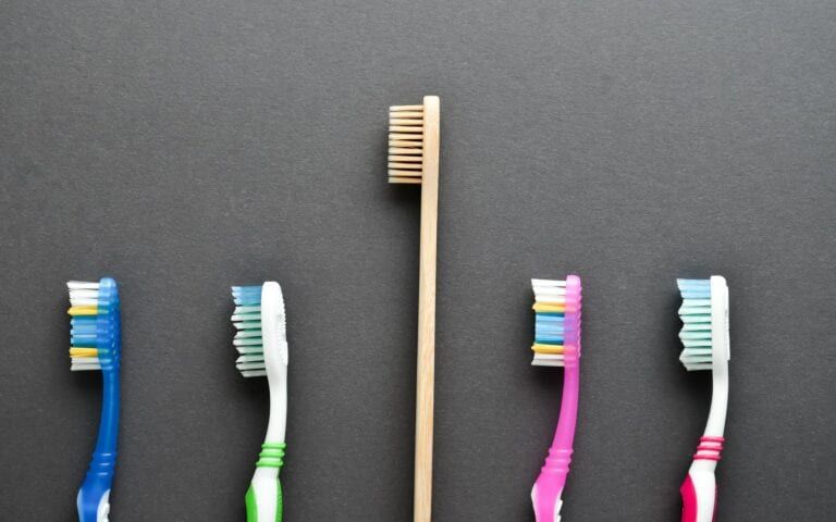 A bamboo toothbrush amongst plastic